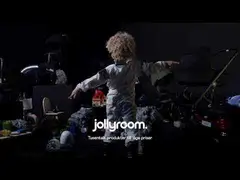 Jollyroom campaign photograph of a child surrounded by toys and family products.